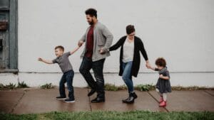 Family Of Four Walking At The Street