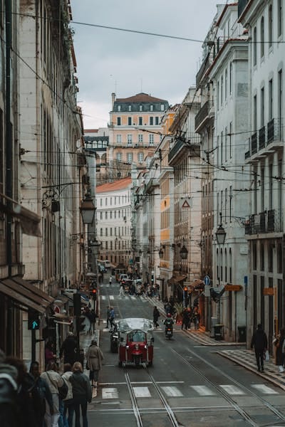 Charming view of a bustling street in central Lisbon with historical architecture.
