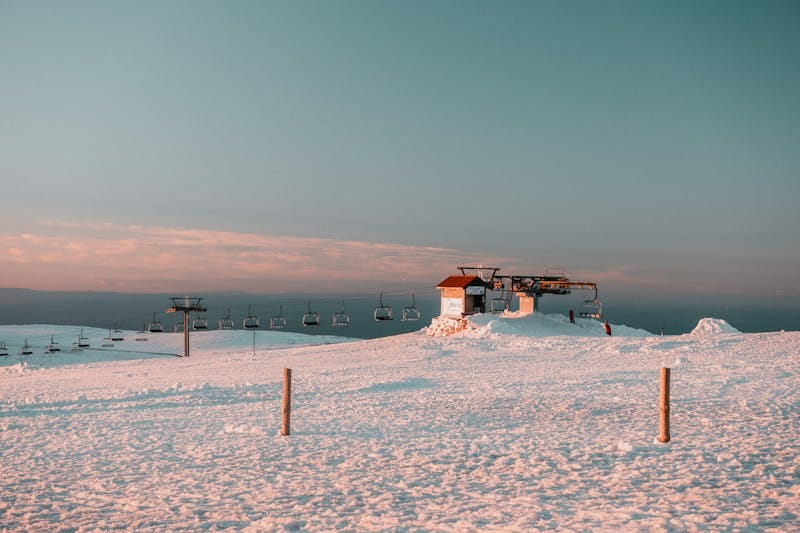 Serene winter landscape of a ski lift at Serra da Estrela, Portugal during sunset.