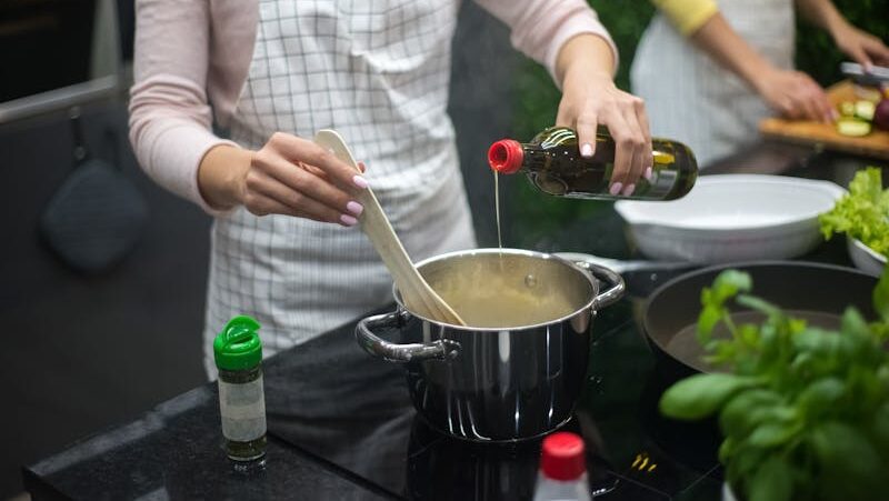 Two women preparing a meal in a modern kitchen with fresh ingredients.