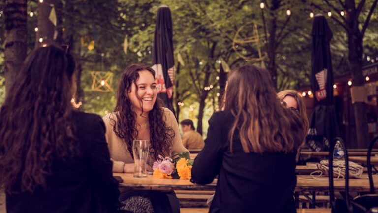 Group of women enjoying conversation at an outdoor cafe in Brussels.